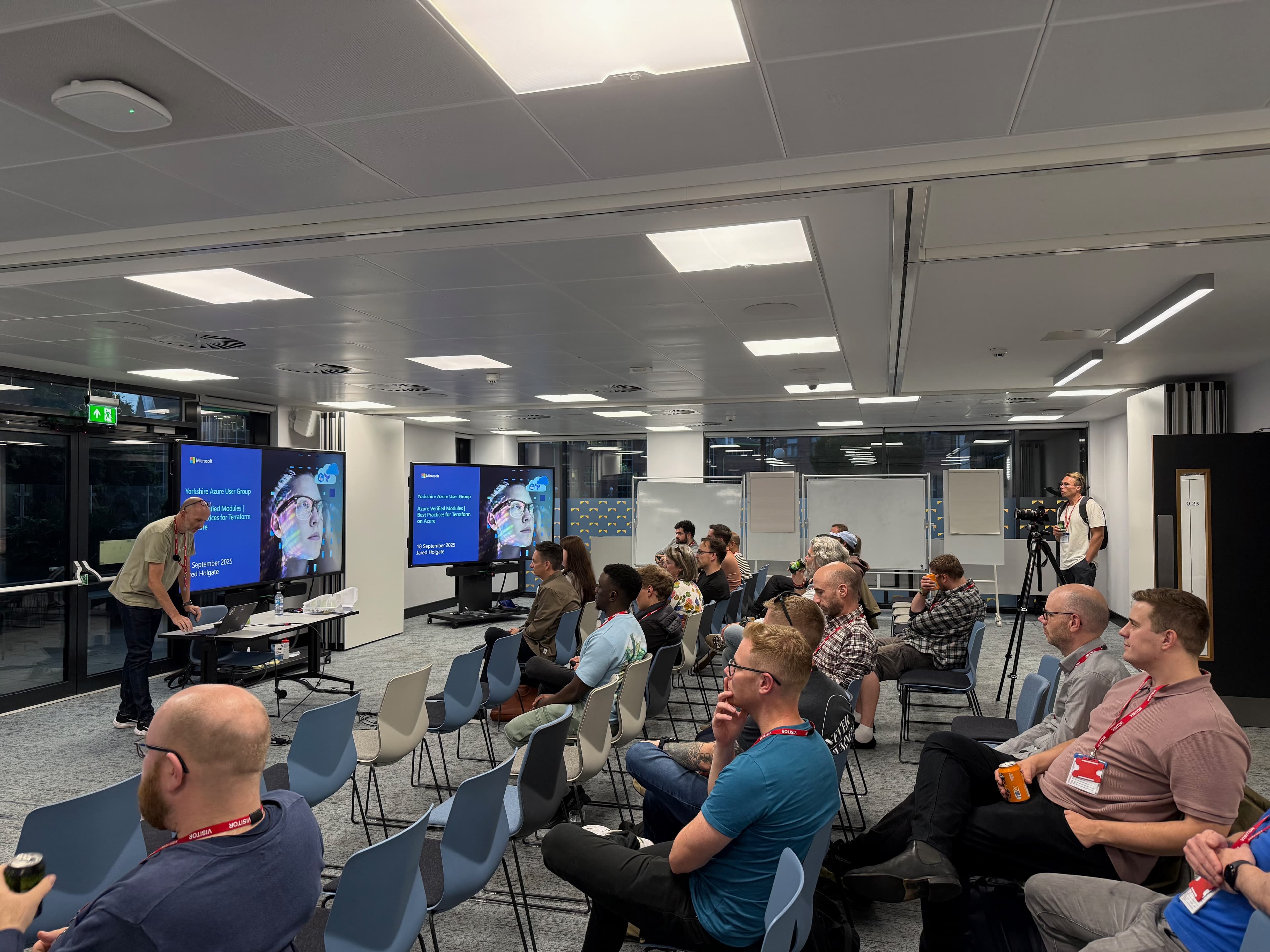 Speaker presenting to a meetup audience in a modern office
